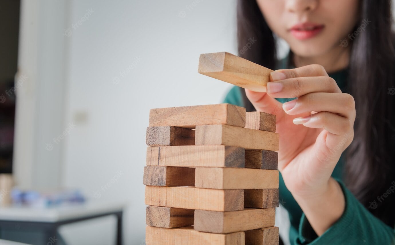 young business woman asian playing with wooden blocks